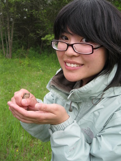 Katherine in the field with a frog